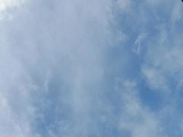 Beautiful white clouds on deep blue sky background. Large bright soft fluffy clouds are cover the entire blue sky. photo