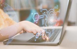 e learning kid activity concept, girl hand typing on computer laptop and virtual diagram, kid study and development photo