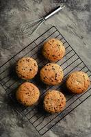 Homemade chocolate chip cookies on black baking cooling tray and abstract background photo