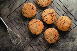 Homemade chocolate chip cookies on black baking cooling tray and abstract background photo