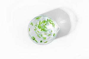 organic cosmetics, natural cosmetics, biofuels, algae. Natural green laboratory. Experiments. Laboratory cup with green plants on a light background. photo