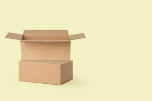 several cardboard boxes for delivery, parcels. On a yellow background. photo