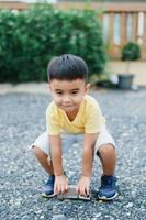 Portrait of an Asian boy wearing a yellow t-shirt. Blurred background. photo