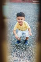 Smiling Asian boy in yellow t-shirt. Blurred background. photo