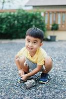 Smiling Asian boy in yellow t-shirt. Blurred background. photo