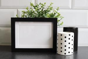 Black frame mockup with monochrome candle photo