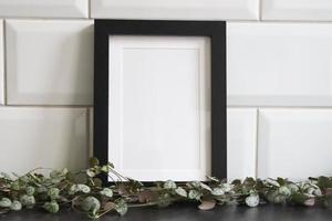Black frame mockup with pearl of hearts plant photo