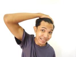 Shocked face of Asian man getting bald and lost hair in isolated white background photo