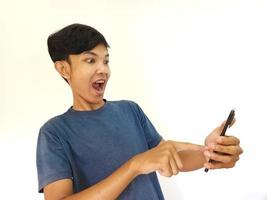Asian man being Shock and surprised after watching from smartphone photo