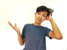 asian man scratching hair with confused and clueless face photo