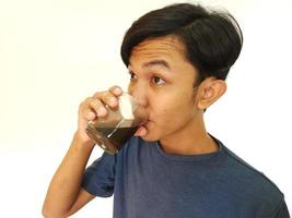 Asian man drink a shot of coffee photo