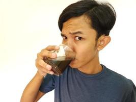 Asian man drink a shot of coffee photo