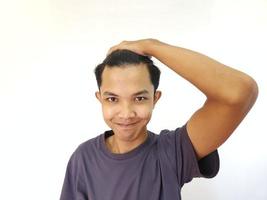 Shocked face of Asian man getting bald and lost hair in isolated white background photo