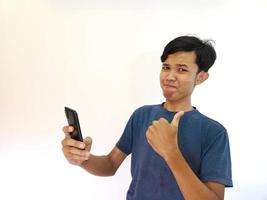 man use smartphone with thumb up as a recommendation. copy space photo