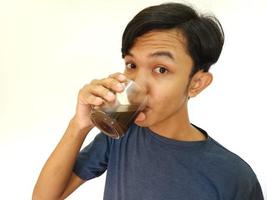 Asian man drink a shot of coffee photo