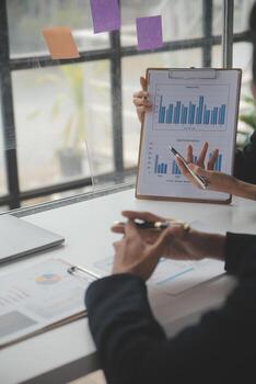 Business professionals. Group of young confident business people analyzing data using computer while spending time in the office photo