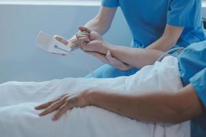 Women Asian doctors hold the patient hand and encourage and provide medical advice While checking the patient health in bed. Concept of Care and compassion, antenatal care, Threatened abortion photo