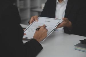 Close up view of job interview in office, focus on resume writing tips, employer reviewing good cv of prepared skilled applicant, recruiter considering application, hr manager making hiring decision photo