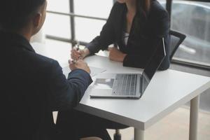 Close up view of job interview in office, focus on resume writing tips, employer reviewing good cv of prepared skilled applicant, recruiter considering application, hr manager making hiring decision photo