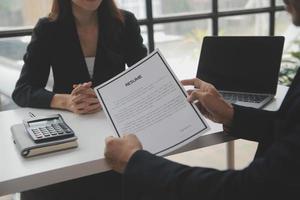 Close up view of job interview in office, focus on resume writing tips, employer reviewing good cv of prepared skilled applicant, recruiter considering application, hr manager making hiring decision photo