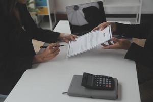 Close up view of job interview in office, focus on resume writing tips, employer reviewing good cv of prepared skilled applicant, recruiter considering application, hr manager making hiring decision photo