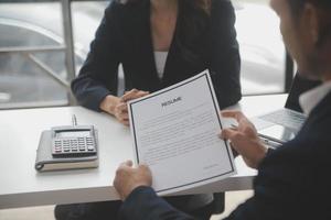 Close up view of job interview in office, focus on resume writing tips, employer reviewing good cv of prepared skilled applicant, recruiter considering application, hr manager making hiring decision photo