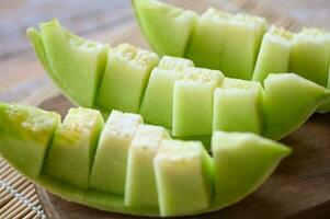 cantaloupe melon on wooden plate, cantaloupe thai slice fruit for health green cantaloupe thailand photo