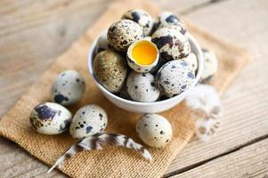 quail eggs on bowl, fresh quail eggs on wooden table background, raw eggs with peel egg shel photo