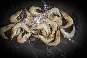 Raw shrimps prawns on ice in white plate, Fresh shrimp seafood , white shrimp photo