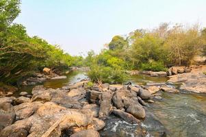 River stream waterfall in forest landscape, beautiful nature water stream with  rocks in the tropical forest little mountain waterfall water flowing and stone clear water in mountain river with tree photo