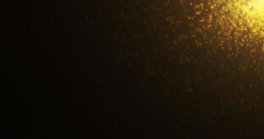 bokeh de luxo dourado em partículas flutuando no ar. fundo de partículas de poeira e brilho. fundo preto, use a tela do modo de mesclagem. animação em loop video