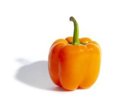 Single orange pepper with shadow on white background isolated interesting creative photo