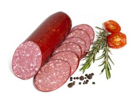 Sausage slices with rosemary and cherry tomato. Semi or half -smoked sausage isolated on white background. Meat delicacies. High quality photo