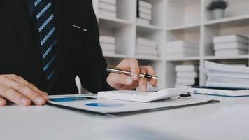 Financial analysts analyze business financial reports on a digital tablet planning investment project during a discussion at a meeting of corporate showing the results of their successful teamwork. video