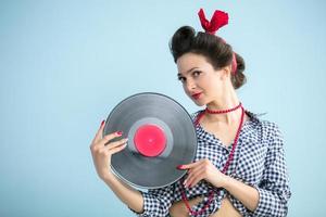 Retro girl with a record.Fifties style woman. photo