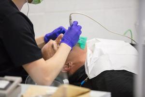 Dental office. The hands of the dentist treats the teeth of the patient. photo