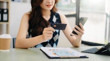 Business woman hands using smartphone and holding credit card as Online shopping photo