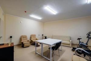 relaxation room with chairs and exercise equipment in office for rest and relax of staff photo