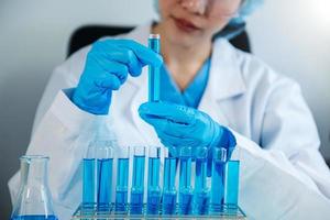 Scientist mixing chemical liquids in the chemistry lab. Researcher working in the laboratory photo