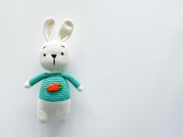 Soft white crochet bunny. on a white background. photo