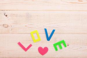 Word love on blue wooden background. Top view photo