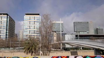 A timelapse on a sunny day of the towers and high rises of barcelona's diagonal mar district next to the sea video