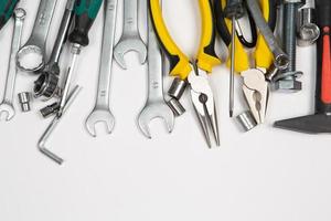 Set of tools for repair in a case on a white background. Assorted work or construction tools. Wrenches, Pliers, screwdriver. Top view photo