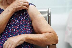 Asian elder senior woman getting vaccine for protect corona virus. photo