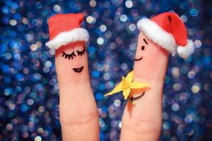 Finger art of Happy couple. Man is giving flowers to woman photo