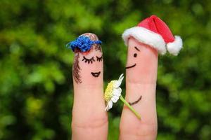 Finger art of Happy couple. Man is giving flowers to woman photo