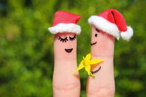 Finger art of Happy couple. Man is giving flowers to woman photo