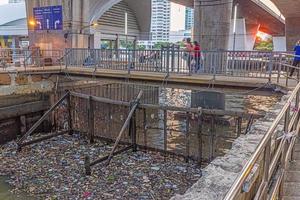 Garbage accumulates at a lock of a canal photo