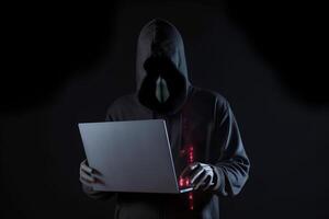 un hacker en un capucha utilizando un ordenador portátil computadora aislado en oscuro antecedentes con neón ligero. ai generado foto