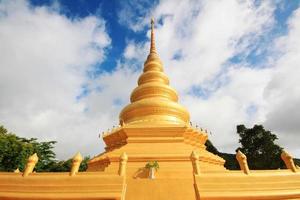 Golden pagoda in temple located on the mountain and very beautiful view in Chiangrai Province, Thailand. photo